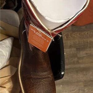 Twisted Box with Red and White Branding on Tan Surface